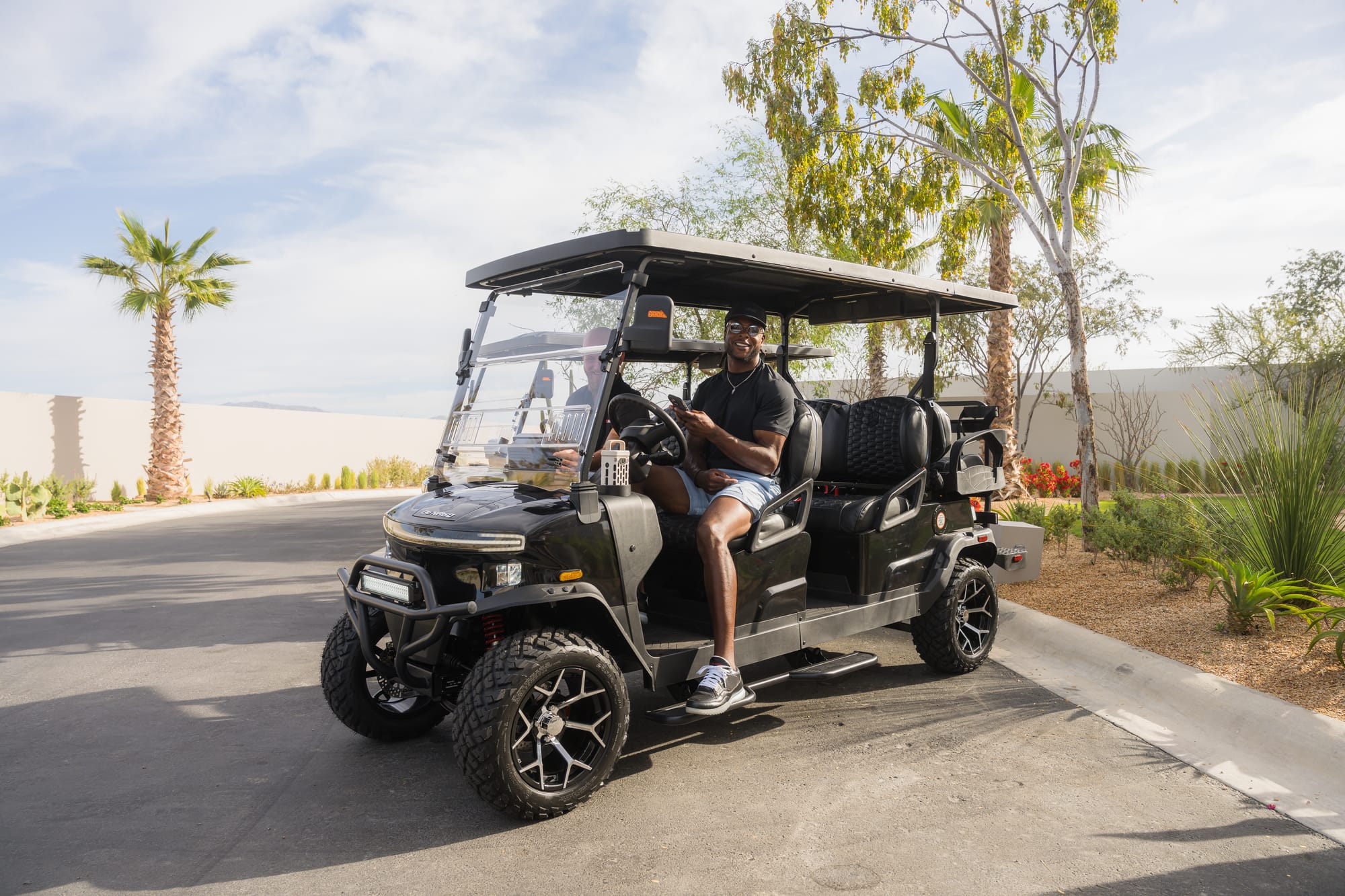 Davante Adams smiling behind the wheel of his Denago Rover XL6